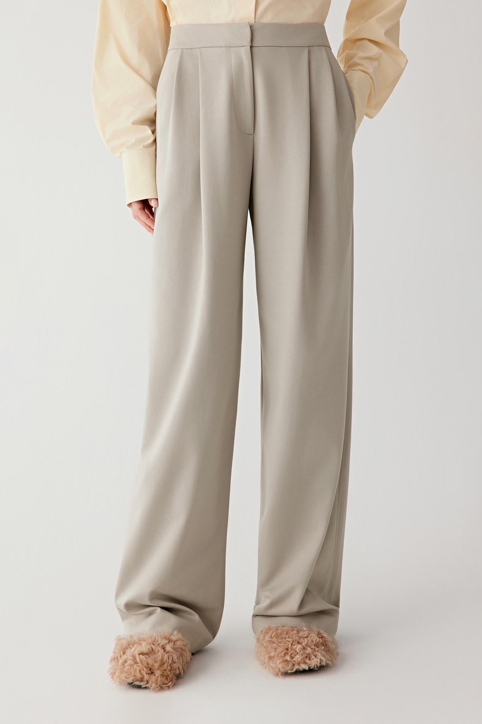 Three-quarter front view showing the fluid drape, soft structure and clean leg line.