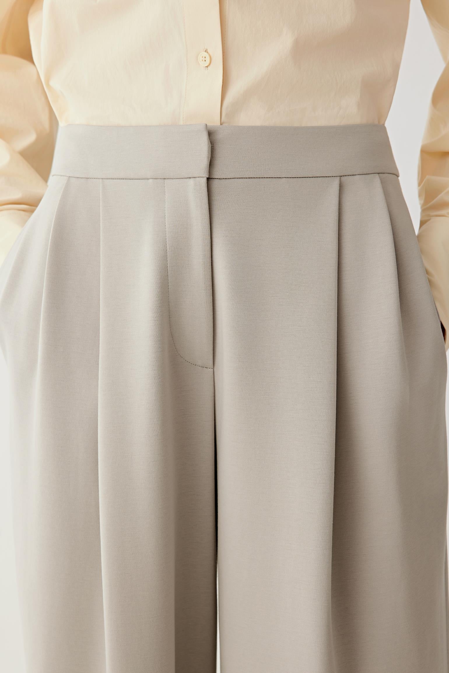 Close-up of the waistband and pocket, showing smooth jersey construction and minimal detailing.