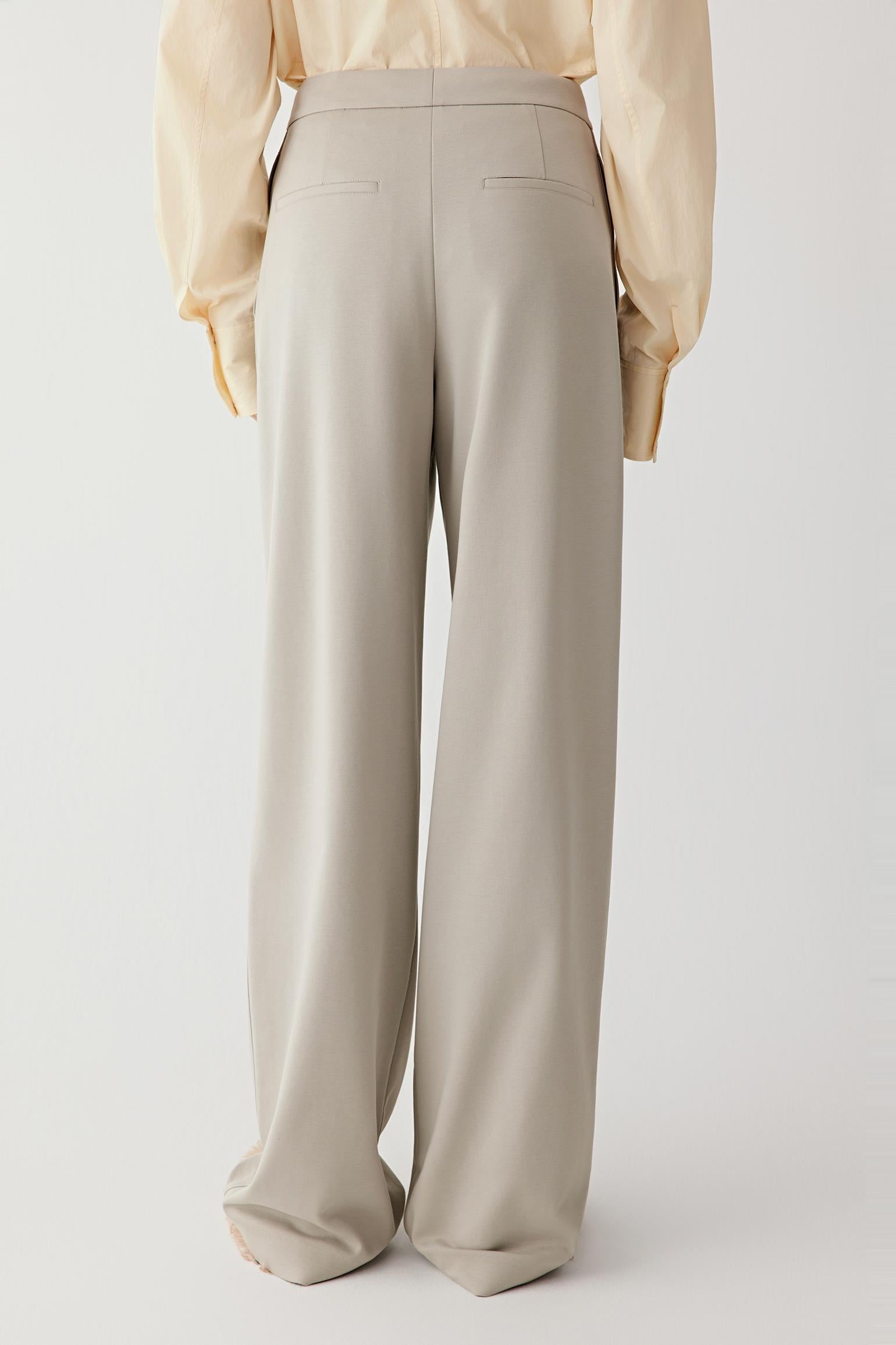 Side view of the trousers, highlighting the natural stretch and ease of movement through the fabric.
