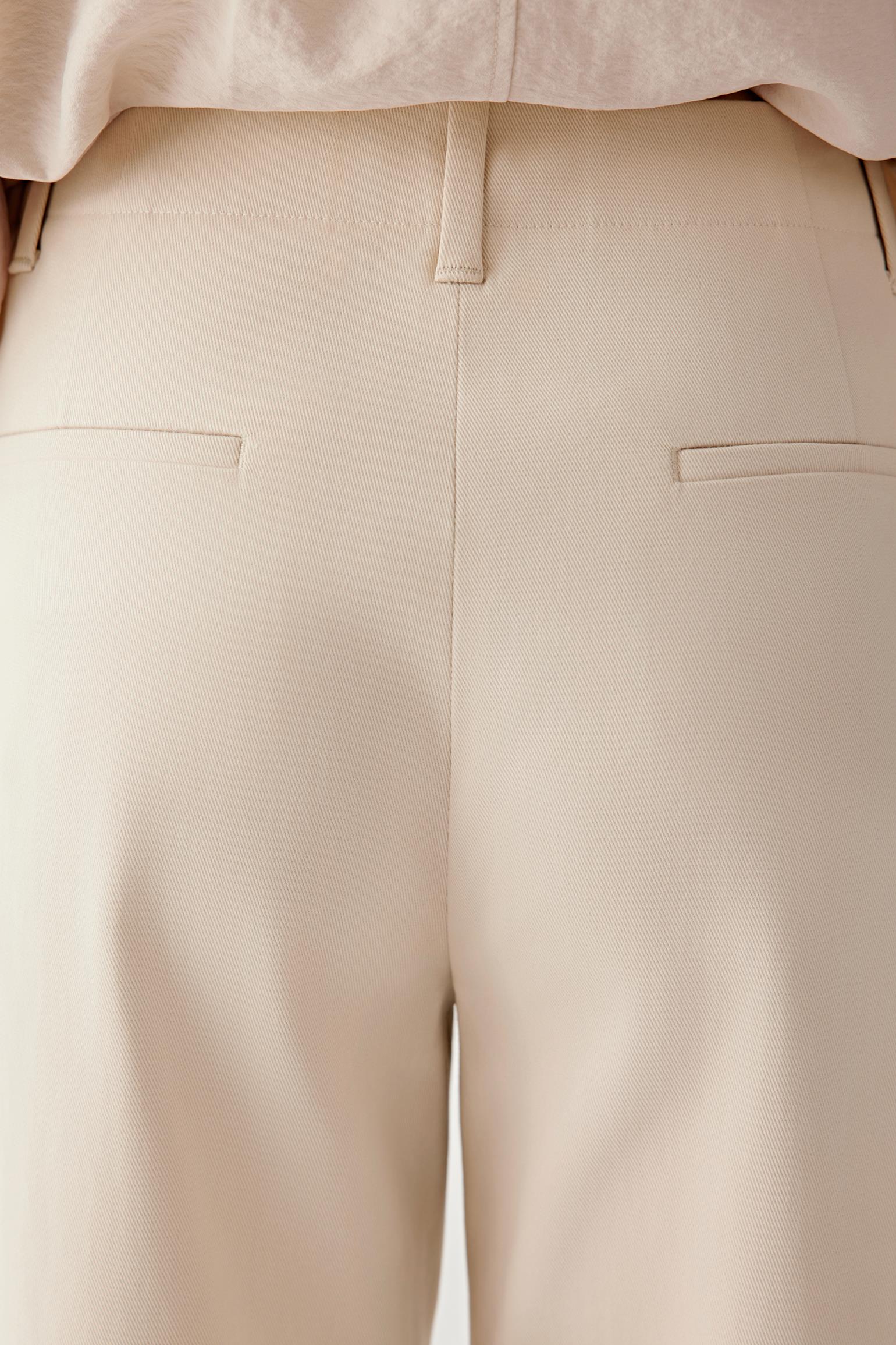 Close-up of waistband and front showing construction, seams and fabric density