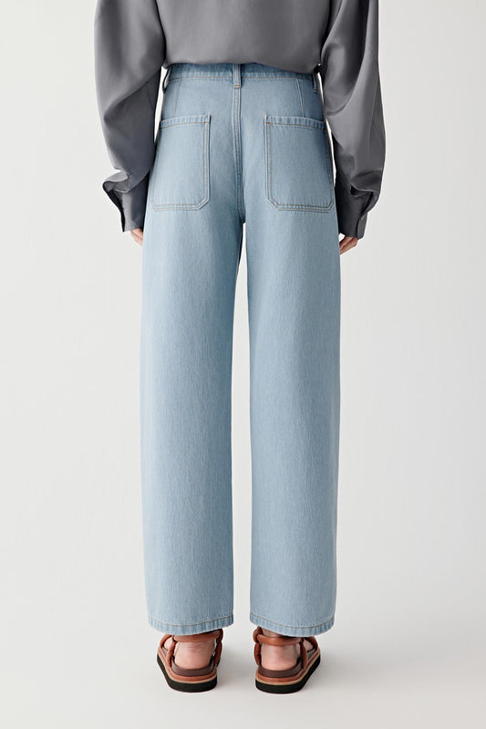 Light blue jeans worn by a person on a white background