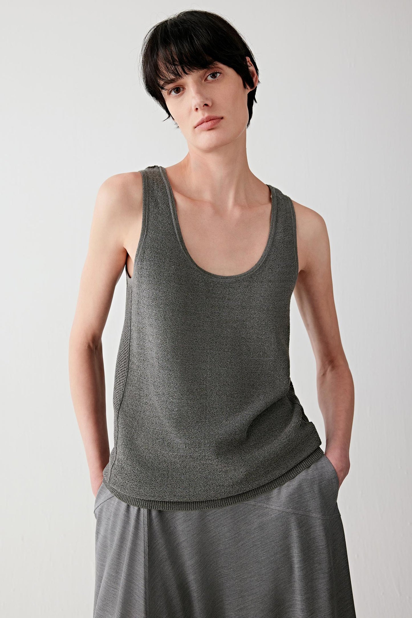 Front or three-quarter view emphasizing the relaxed sleeveless silhouette and round neckline, showing the fluid movement of the lightweight knit fabric