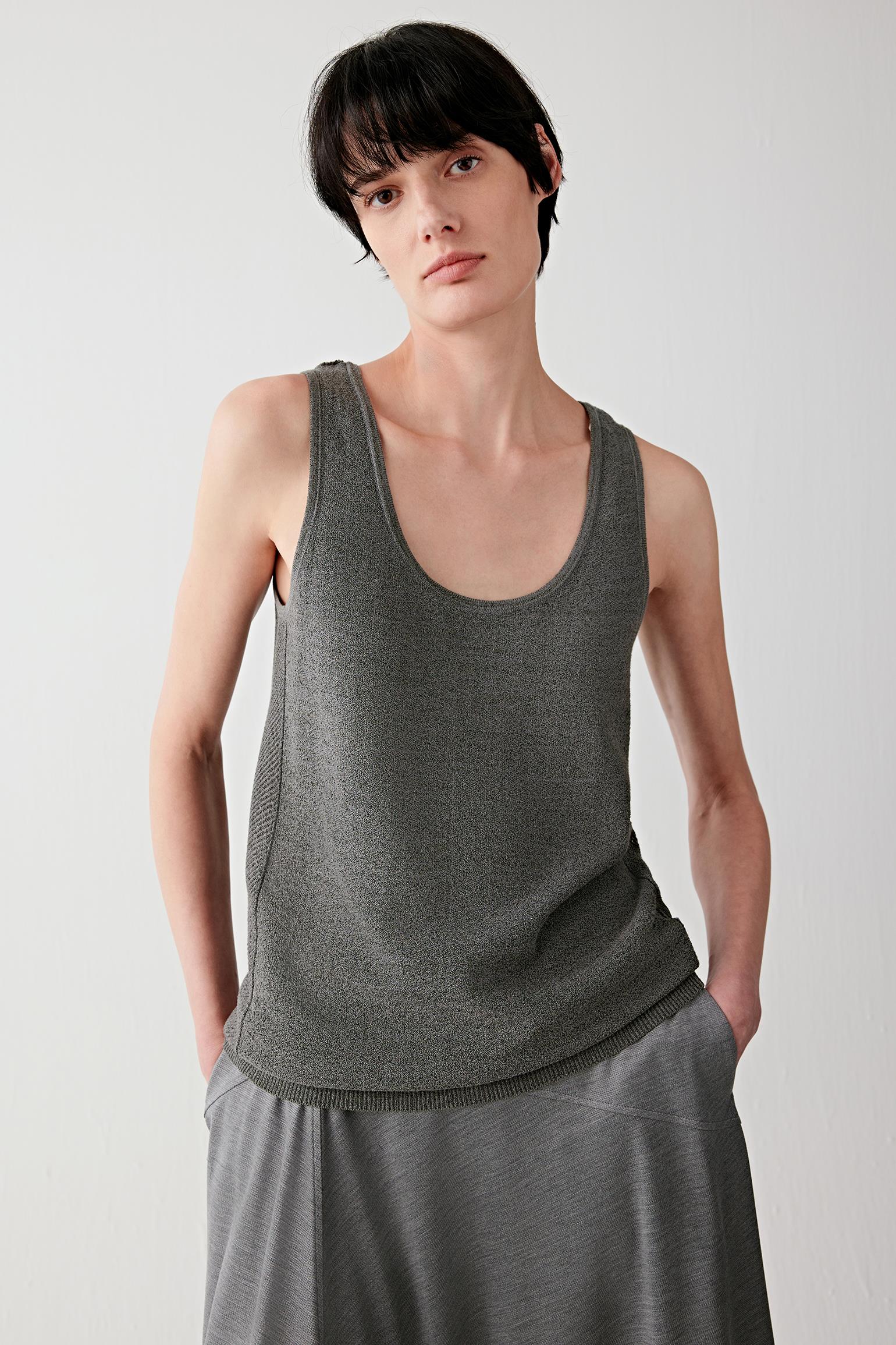 Front or three-quarter view emphasizing the relaxed sleeveless silhouette and round neckline, showing the fluid movement of the lightweight knit fabric