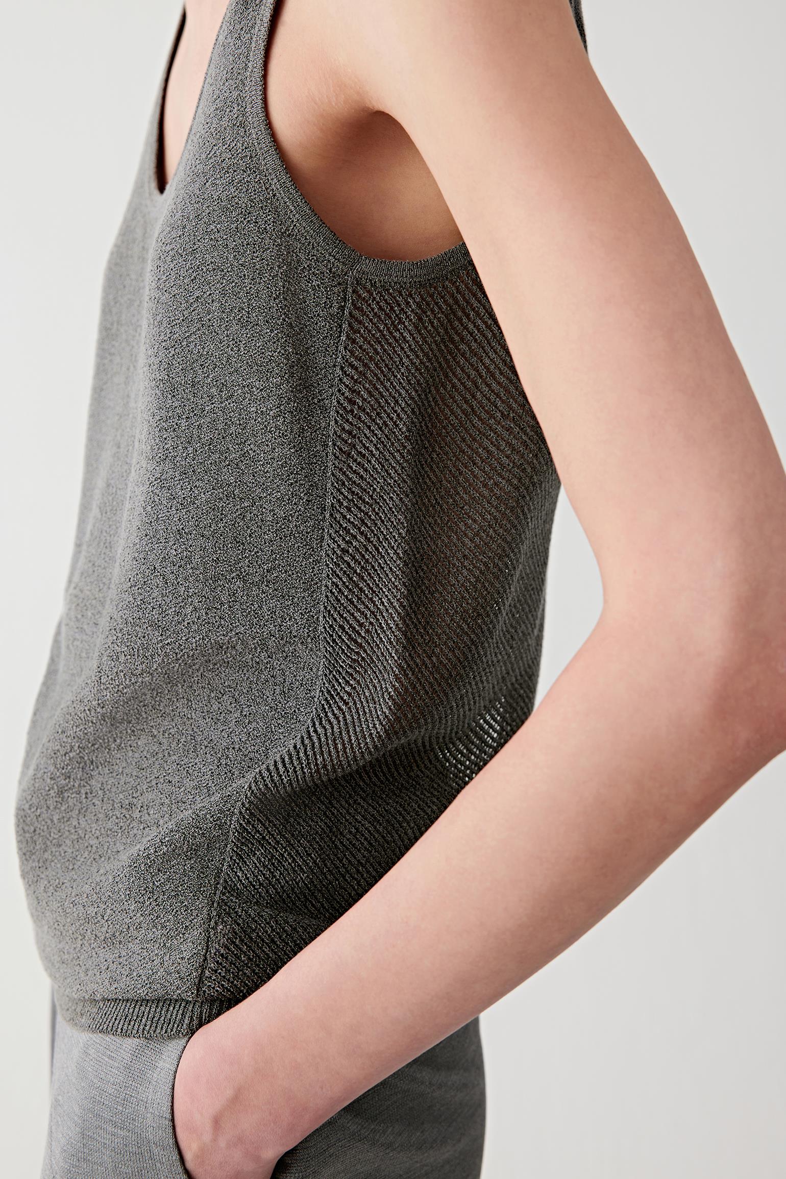 Close-up of side seam and ribbed trim showing the fine knit texture, ribbed finishing and subtle transparency characteristic of the silk and nylon blend