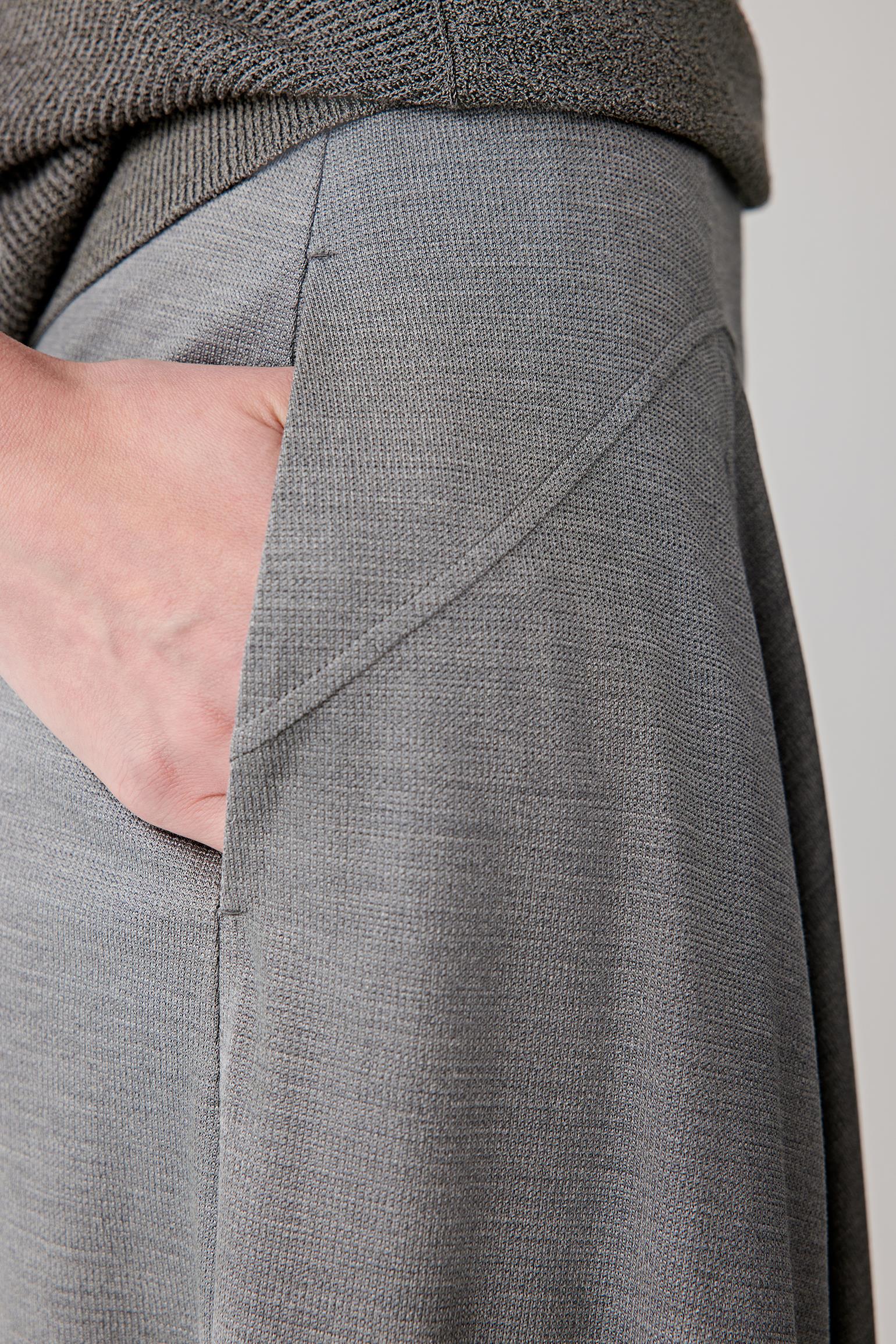 Close-up of waistband and fabric surface showing the smooth stretch jersey construction, soft hand and fluid drape characteristic of spun silk jersey