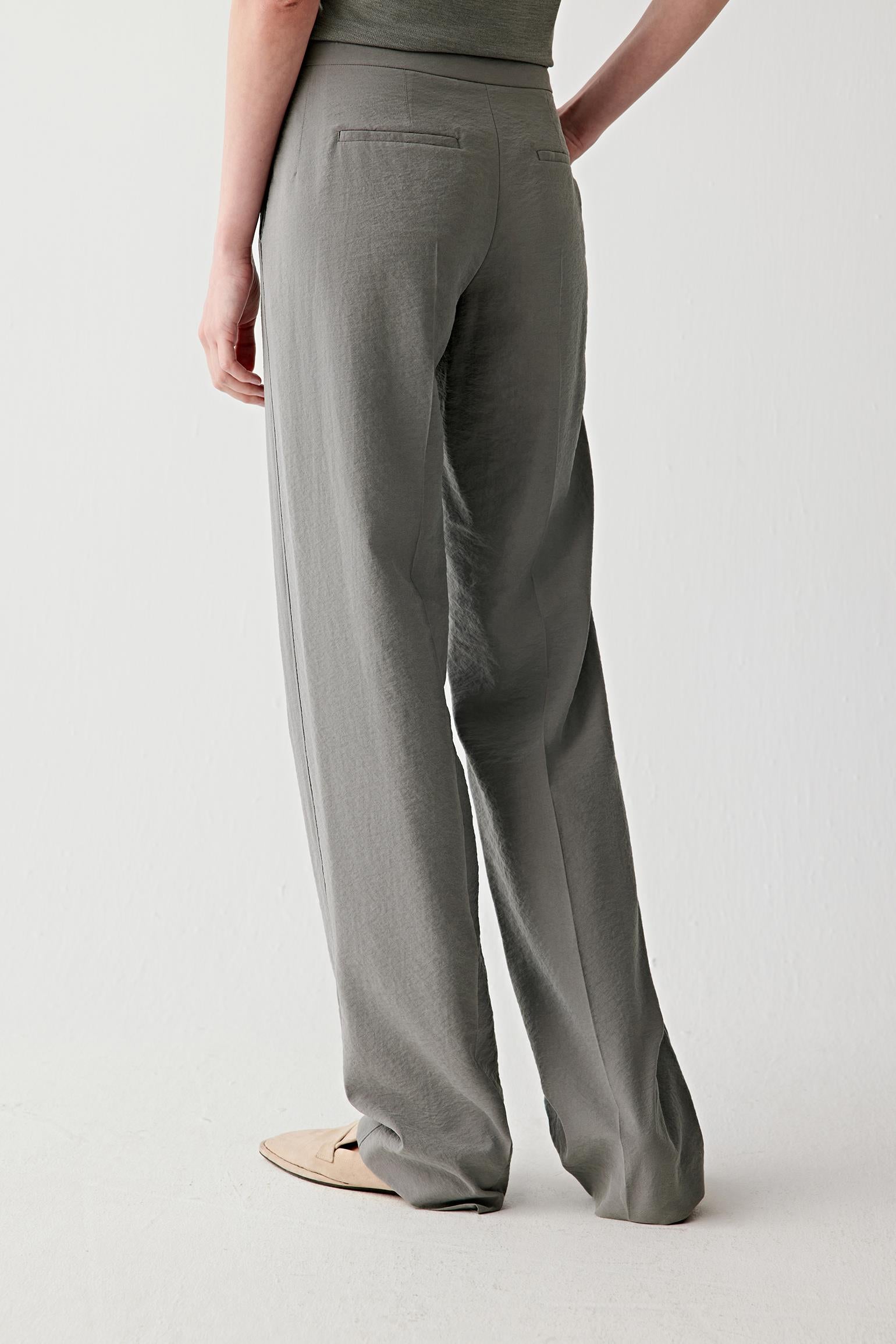 Full-length side or back view highlighting the elongated line and lightweight texture through the trousers