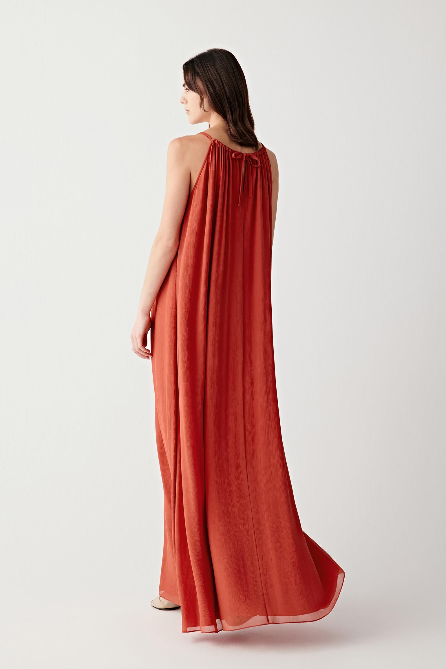 Side or back view emphasizing the airy structure and flowing movement of the lightweight silk fabric. The elongated silhouette maintains a soft and uninterrupted line.
