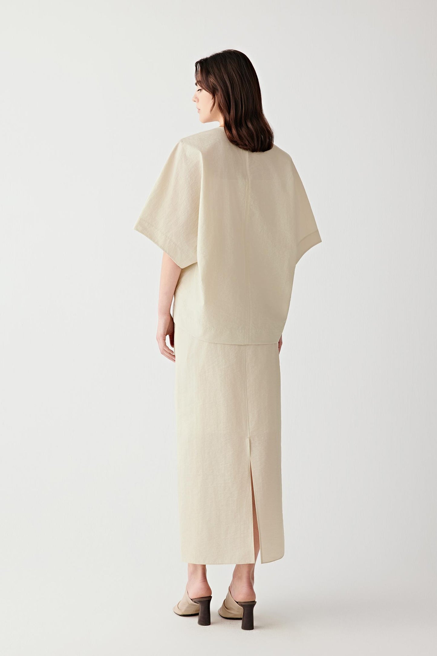 Side or back view highlighting the central seam construction and softly structured silhouette