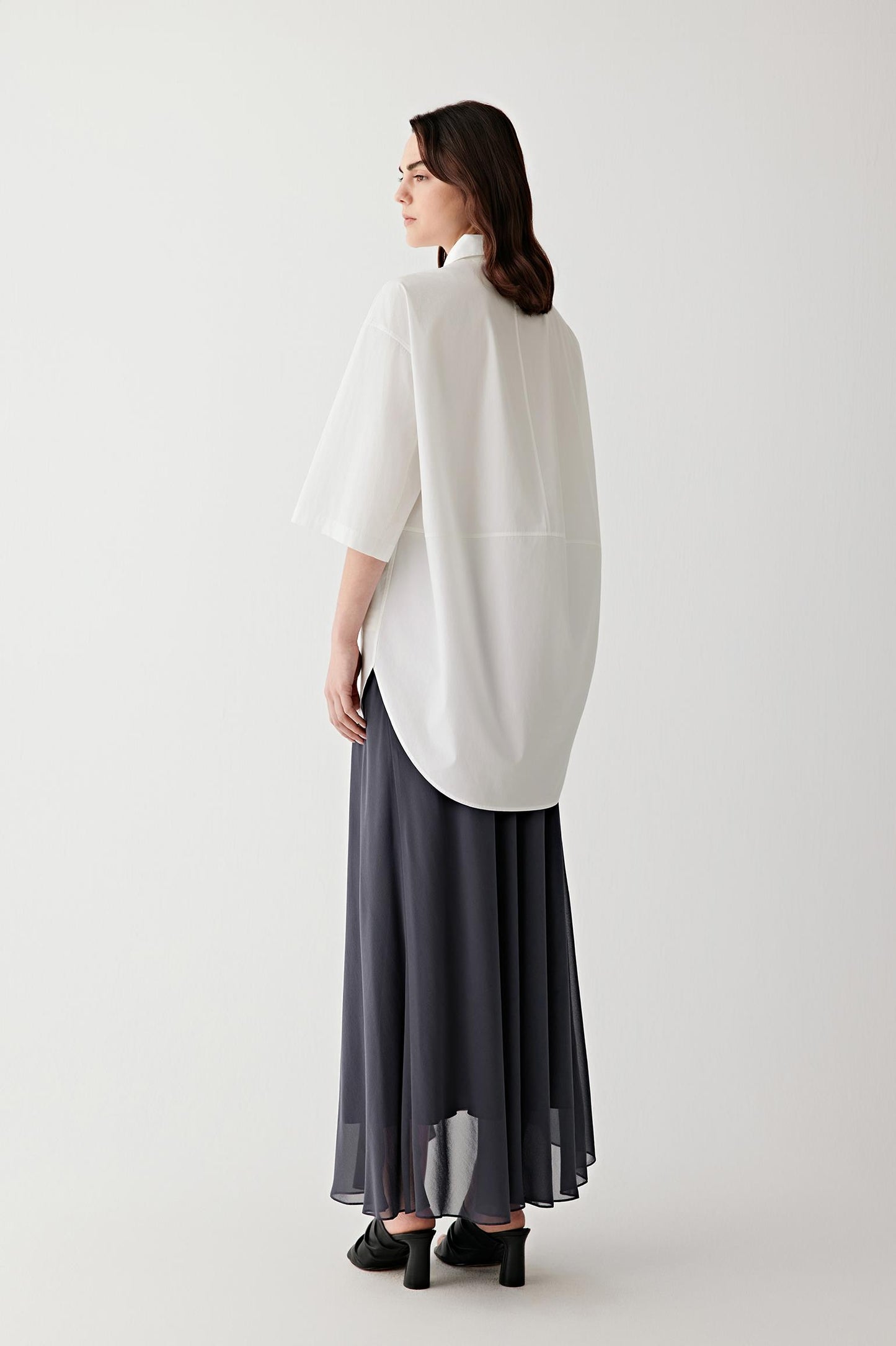Side or back view highlighting the clean construction, collar shape and softly structured silhouette