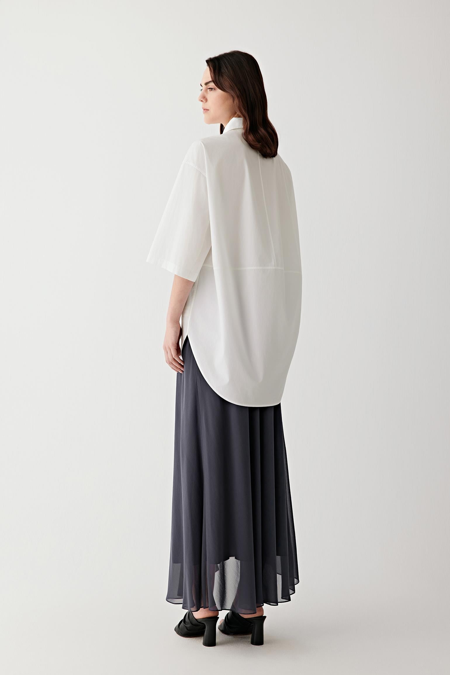 Side or back view highlighting the clean construction, collar shape and softly structured silhouette