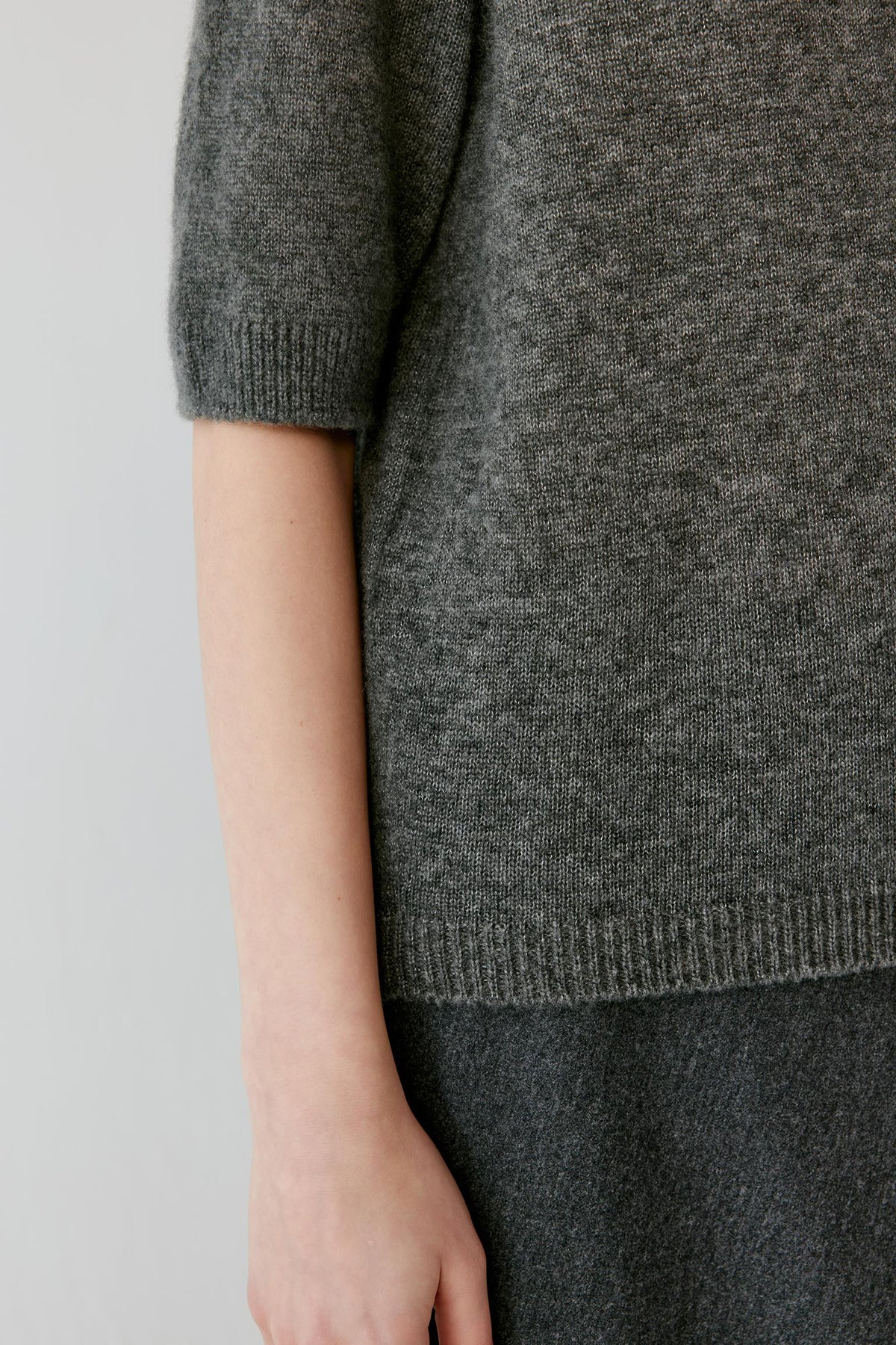 Close-up highlighting the elbow-length sleeve and fine-knit texture of the smoke grey cashmere and silk top.