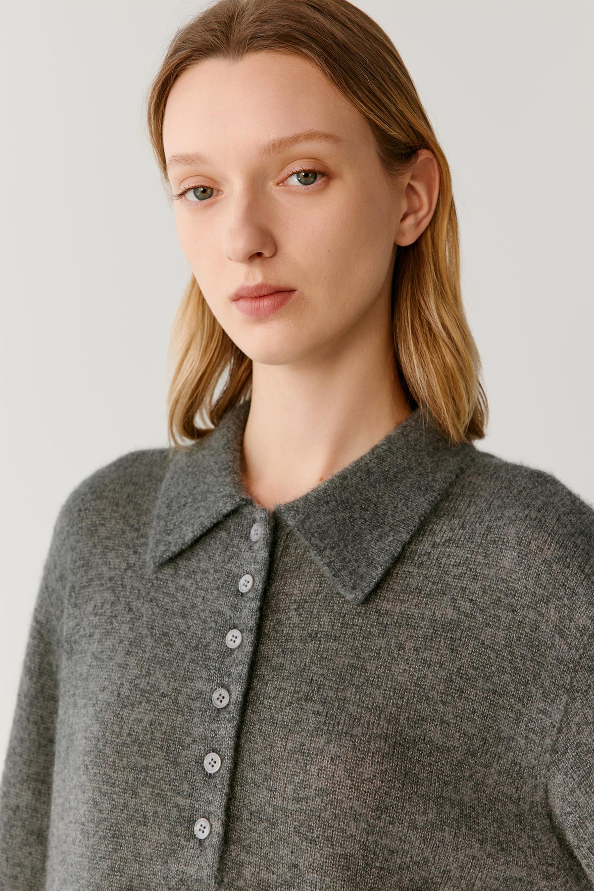 Front close-up highlighting the pointed collar, partial button placket and fine-knit texture of the smoke grey cashmere and silk top.