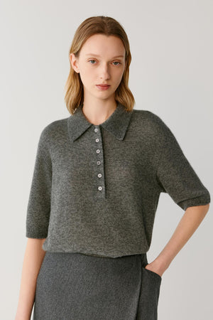 Front view of a woman wearing a smoke grey cashmere and silk top, showing the pointed collar, partial button placket and elbow-length sleeves.