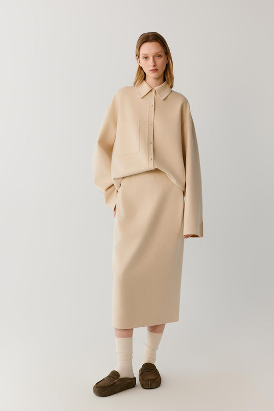 Full-length view highlighting the relaxed cut, dropped shoulders and long length of the beige melange double-face wool overshirt.