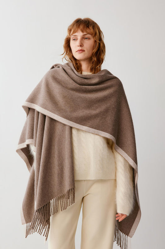 Front view of the brown cashmere shawl wrapped around the shoulders, showing its soft drape and fringed edges.
