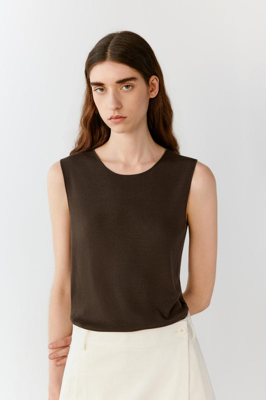 Three-quarter front view highlighting the relaxed fit, lightweight construction and natural drape of the fine-gauge silk knit. The image reveals the clean lines and minimalist silhouette from another angle.