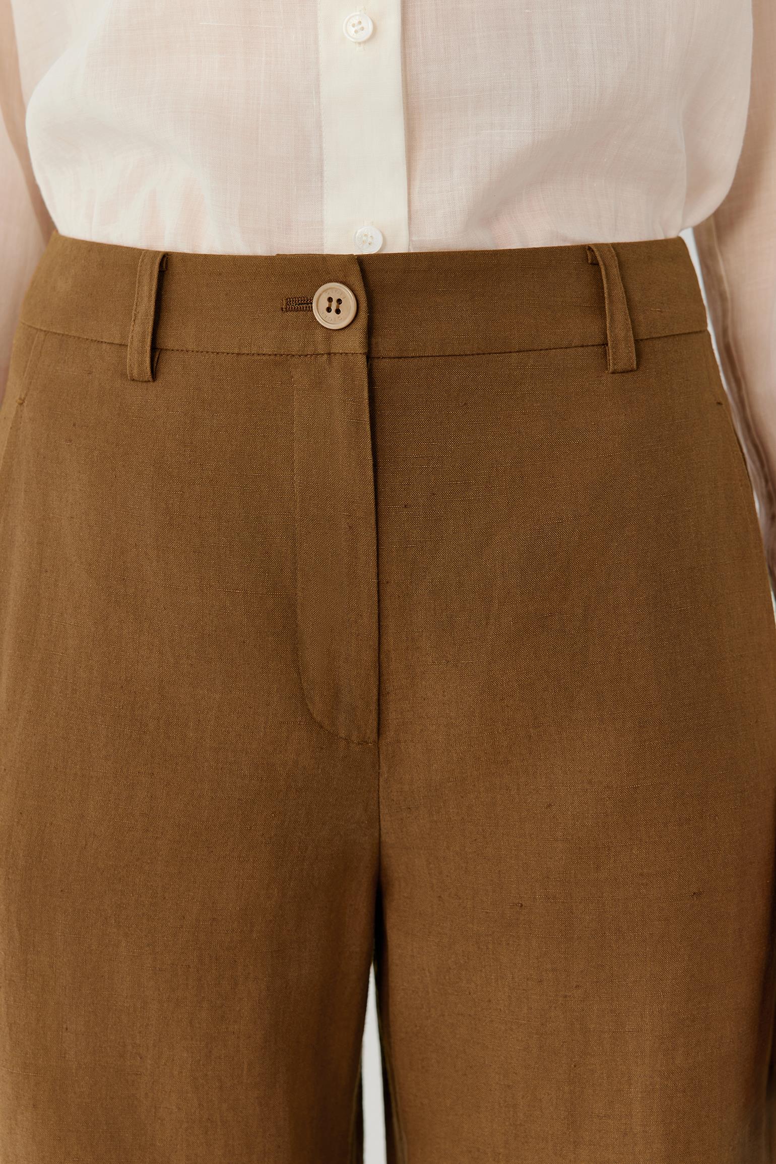 Close-up of the waistband and front fastening, revealing the clean construction, precise tailoring and smooth texture of the silk and linen blend. The image highlights the subtle tonal depth and refined finishing of the fabric.