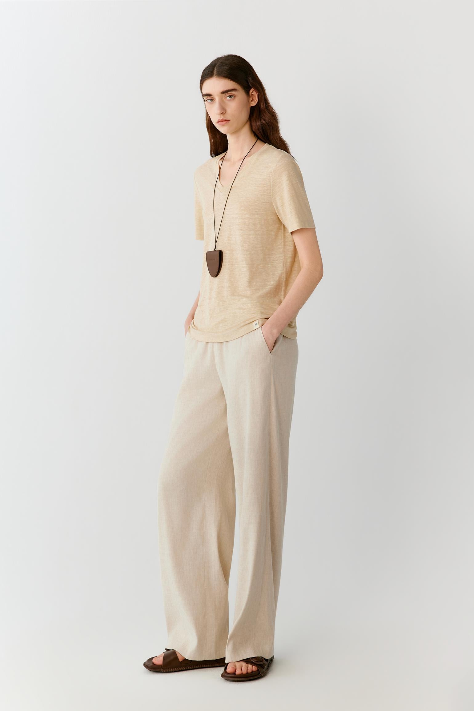 Side view highlighting the straight cut, short sleeves and soft movement of the fabric. The lightweight jersey follows the body naturally while the side slits allow additional ease and fluidity through the hem.
