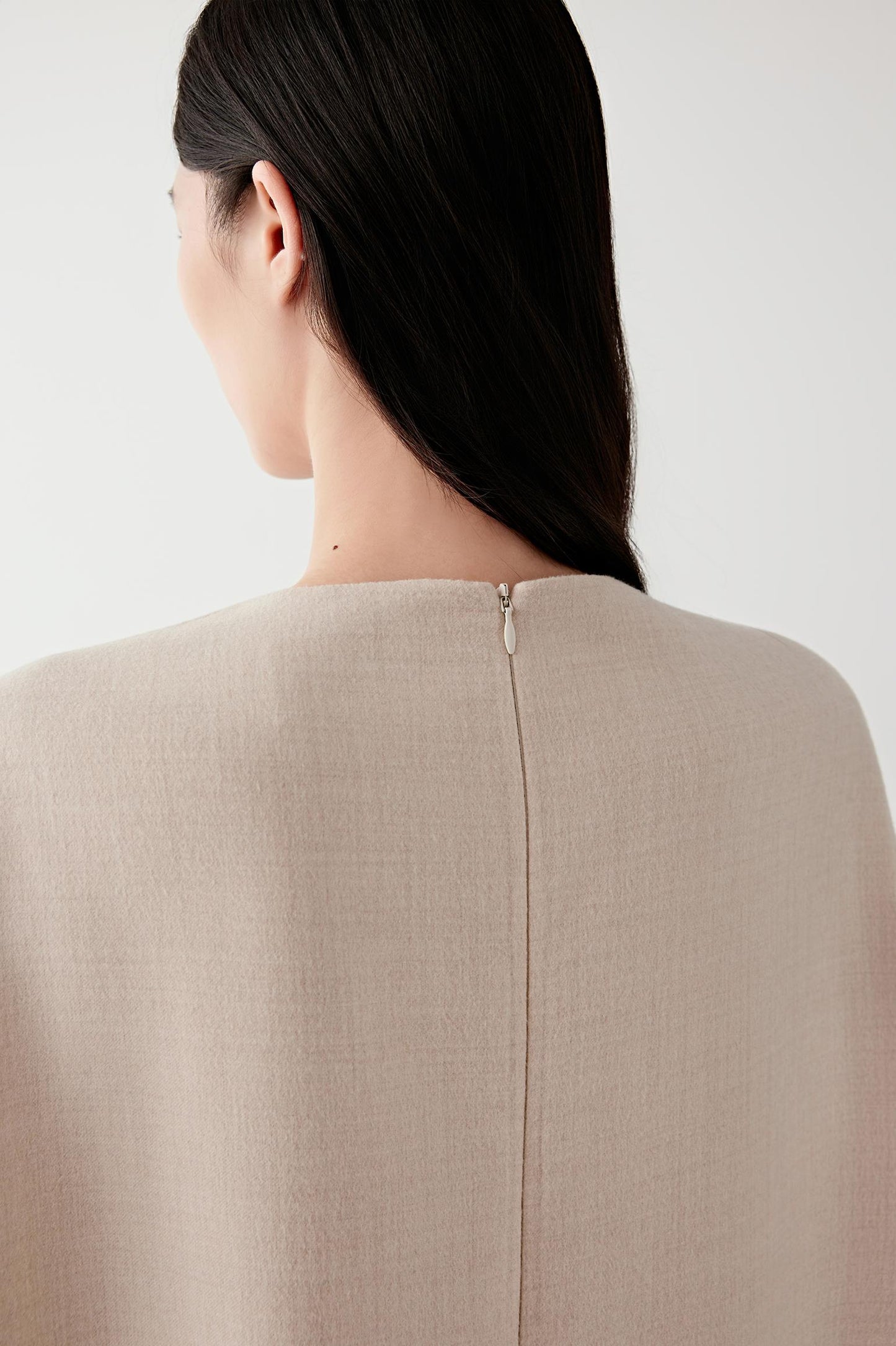Close-up of the upper back of the dress showing the clean neckline finish and the natural drape of the lightweight wool fabric.