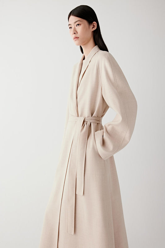 Side view of the coat showing its fluid drape and mid-calf length.
