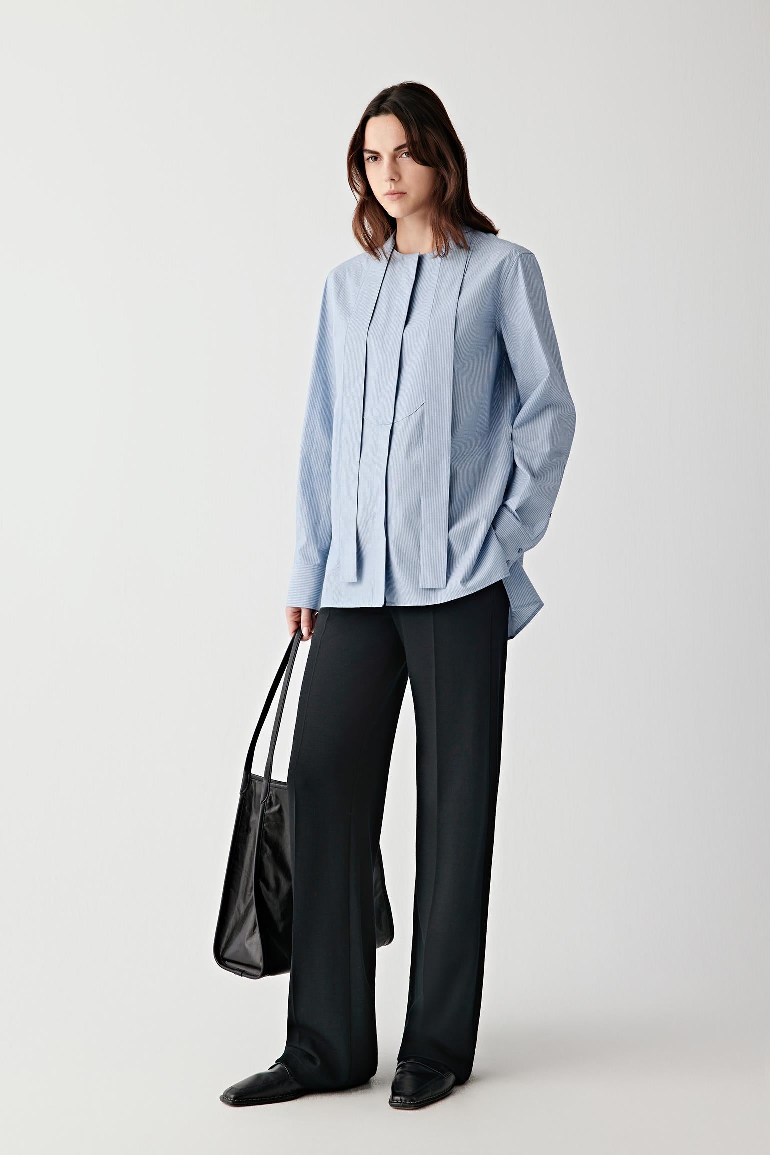Front view emphasizing minimal construction, flat panels and structured silhouette