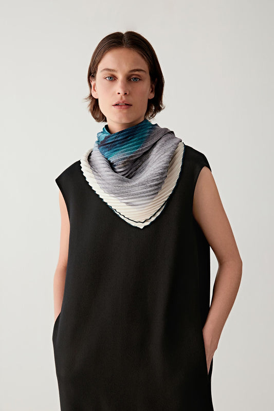 Side view showing the scarf wrapped around the neck with layered folds.
