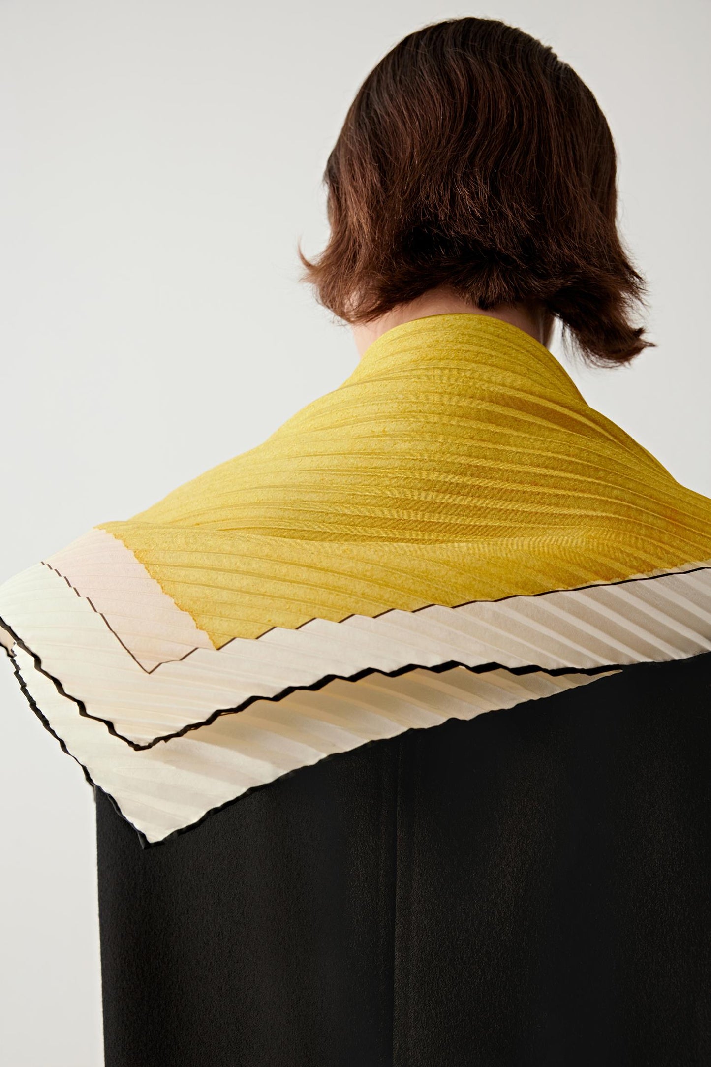 Back view highlighting the bright yellow ground and bordered edges.