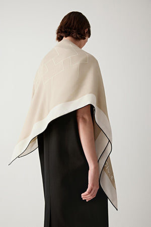 Back view of the scarf falling naturally along the back, emphasizing its smooth surface, clean edges, and soft structure.