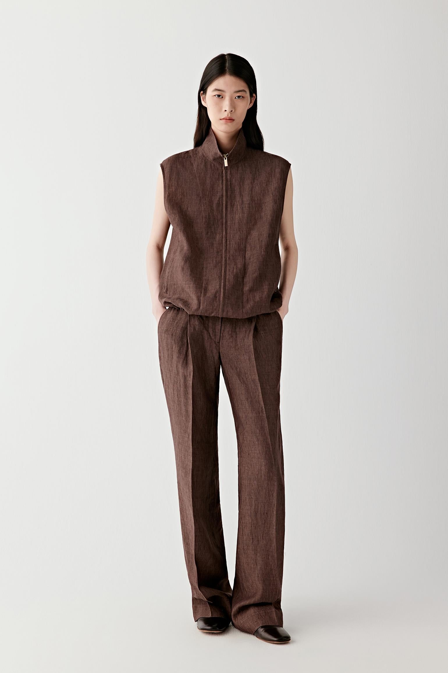 Full-length front view showing the vertical line created by the zip closure, the fitted cut through the body and the balanced proportions with the lower garment