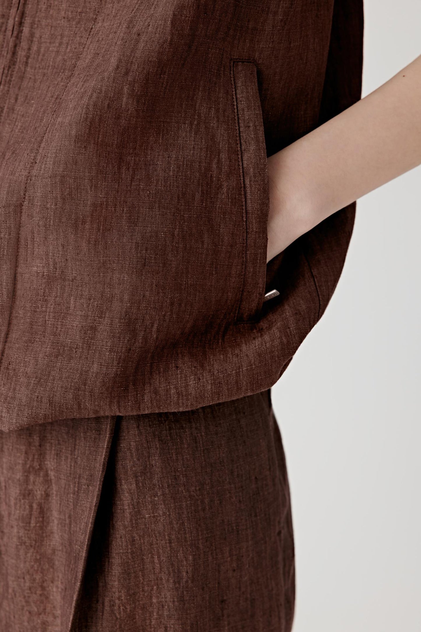 Close-up of the hem and side seam showing construction details, stitching lines and the natural structure of the fabric