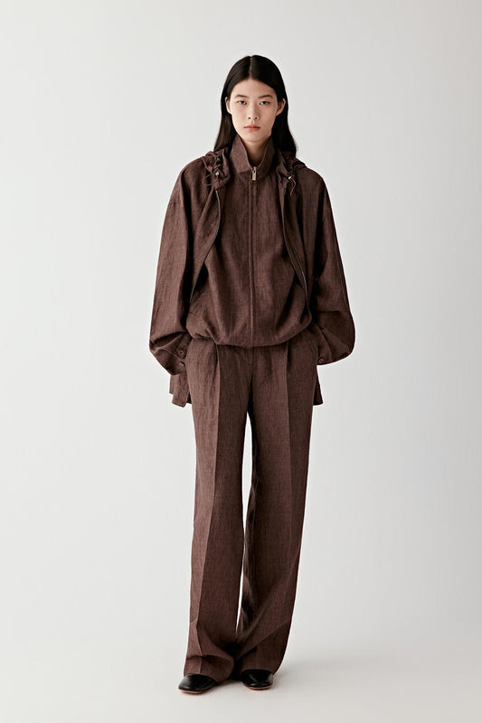 Close-up of the back pocket and upper leg showing seam placement, stitching detail, subtle fading and the natural structure of the lightweight stretch denim fabric