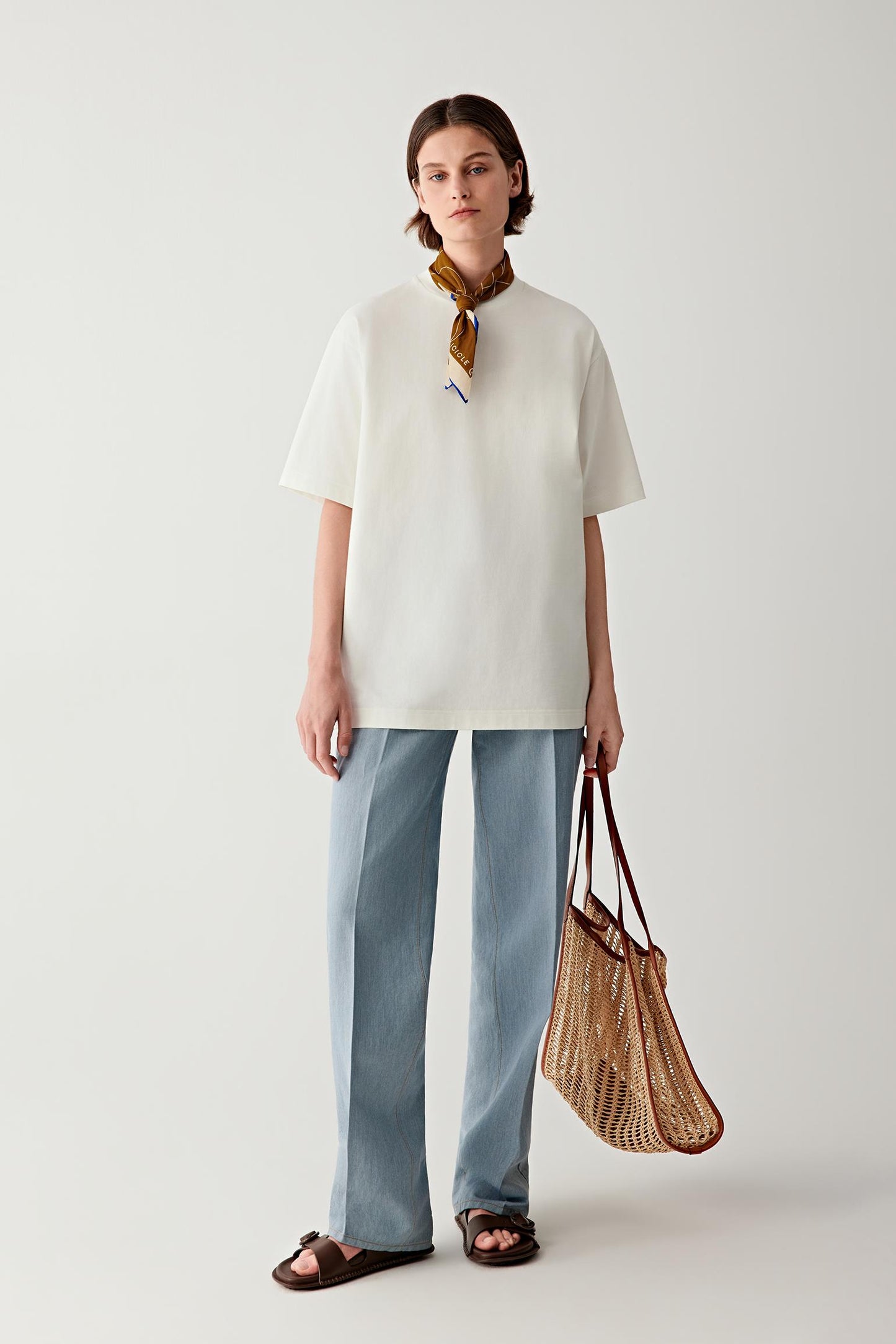 Full-length view showing scale of the tote bag relative to the body, with lightweight drape and relaxed silhouette