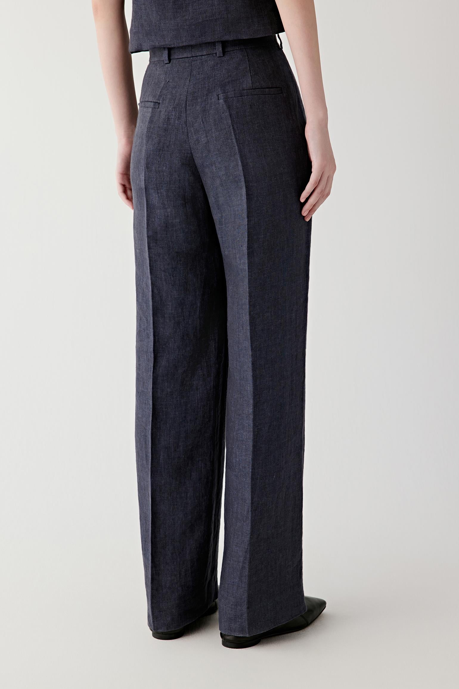 Side or back view emphasizing the balanced proportions and elongated line of the straight-leg construction. The fabric falls softly while retaining a clean architectural shape.
