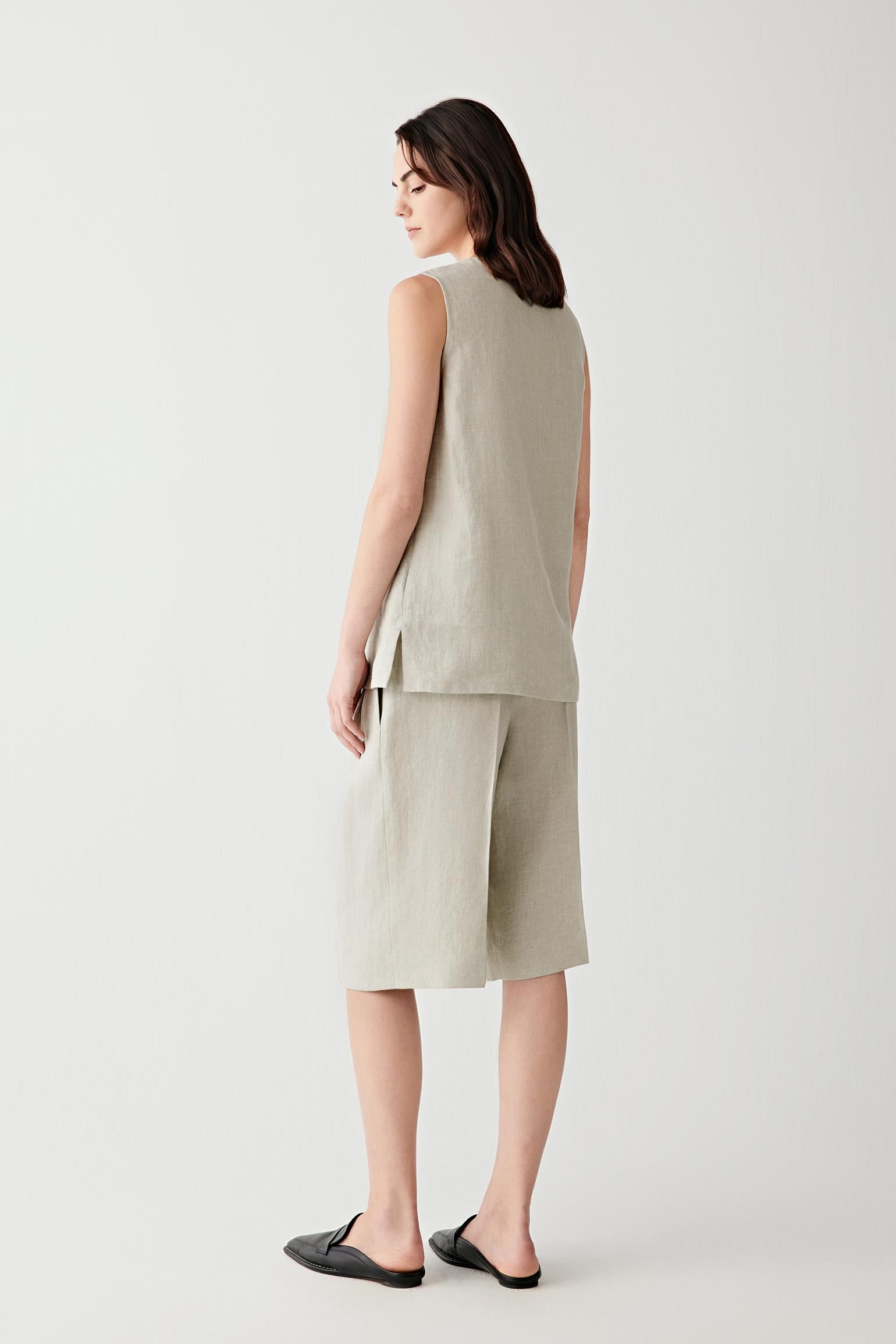 Side or back view emphasizing the soft drape and layered construction of the linen twill fabric. The lightweight weave creates a relaxed and fluid line.