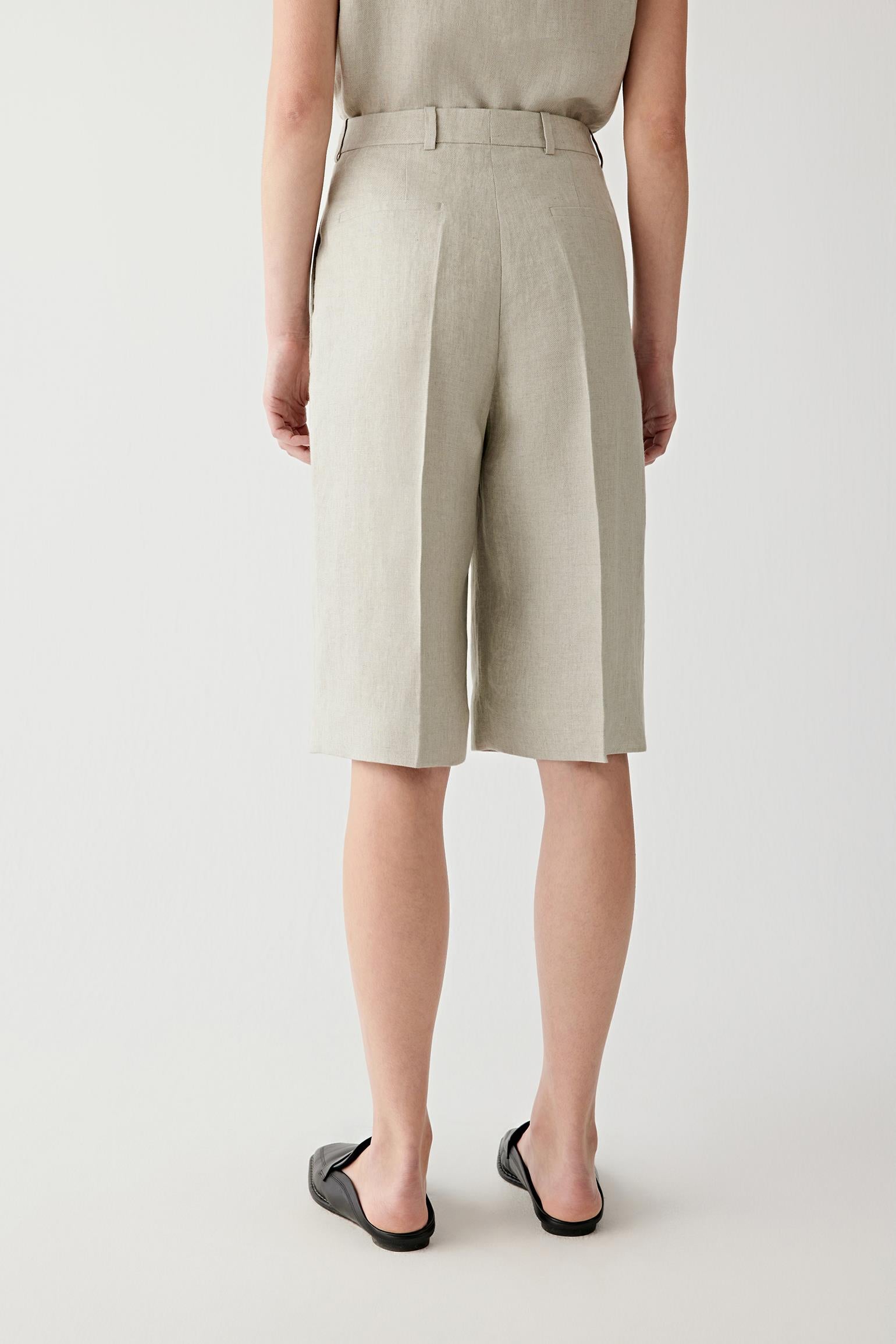 Back or side view emphasizing the fluid movement of the linen twill and the softly structured silhouette. The dry hand of the fabric enhances the relaxed construction.
