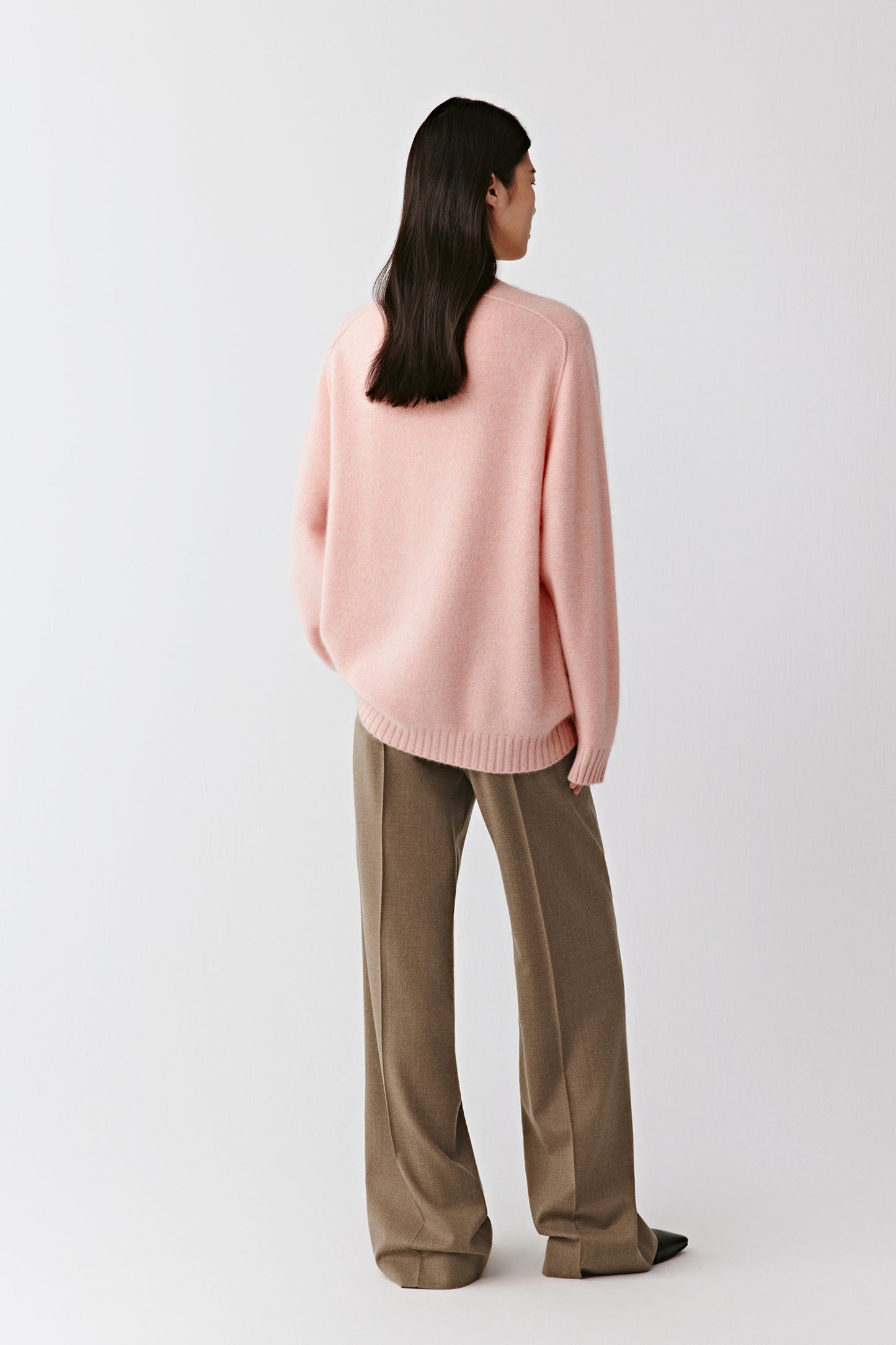 Three-quarter back view emphasizing the smooth fall and ribbed collar detail.
