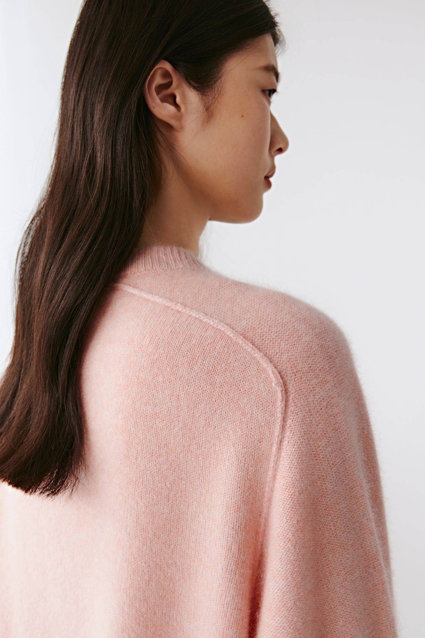 Side view showing the relaxed fit and fluid silhouette of the jumper.