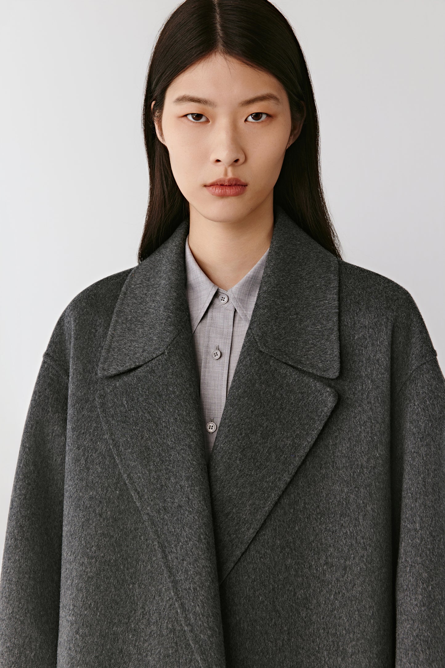Portrait view emphasizing the wide notched lapels and rich cashmere texture.