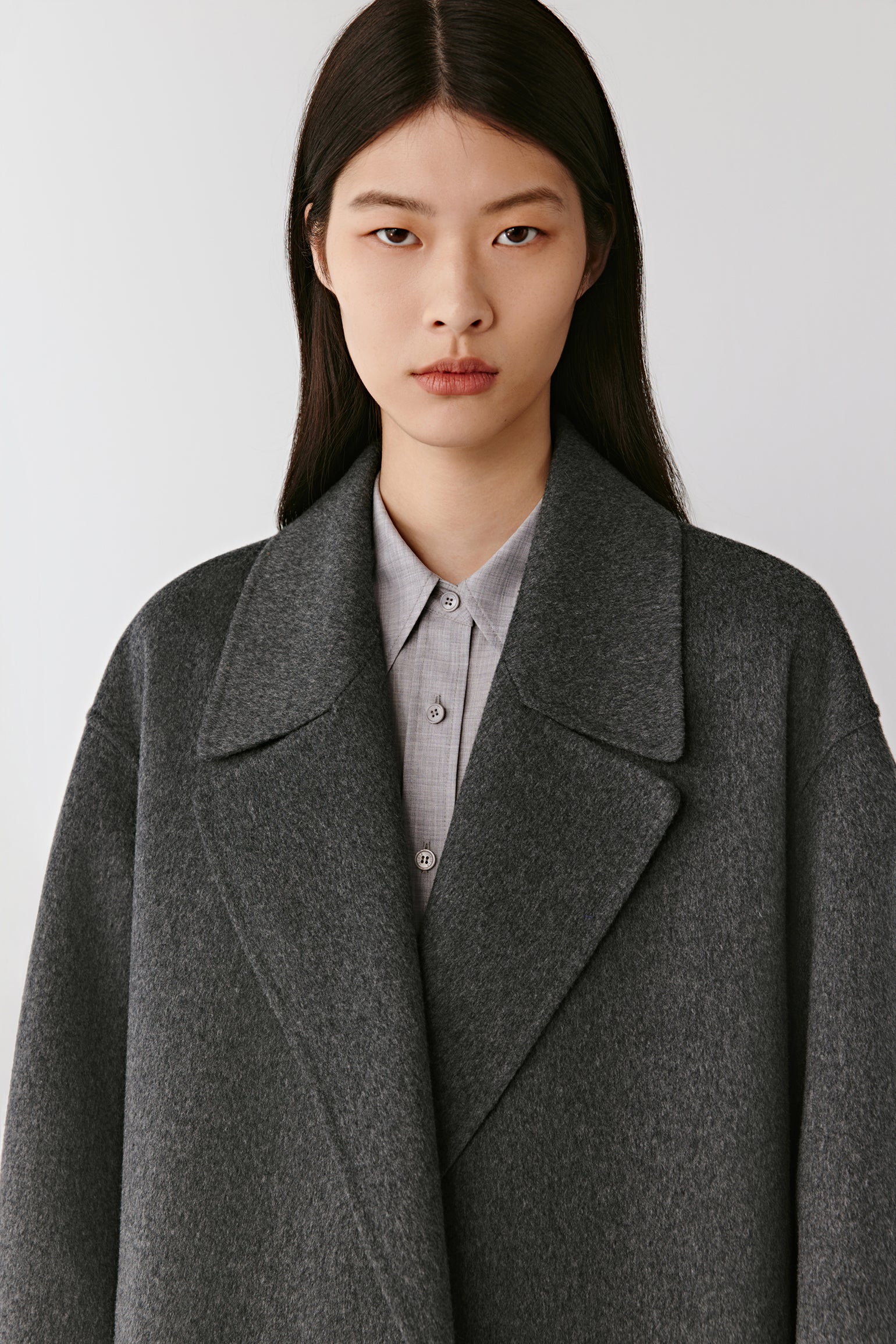 Portrait view emphasizing the wide notched lapels and rich cashmere texture.