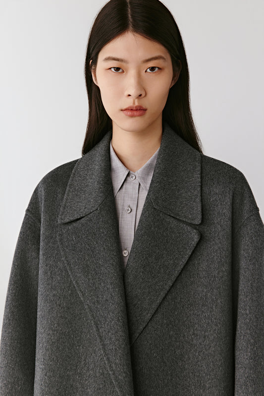 Portrait view emphasizing the wide notched lapels and rich cashmere texture.