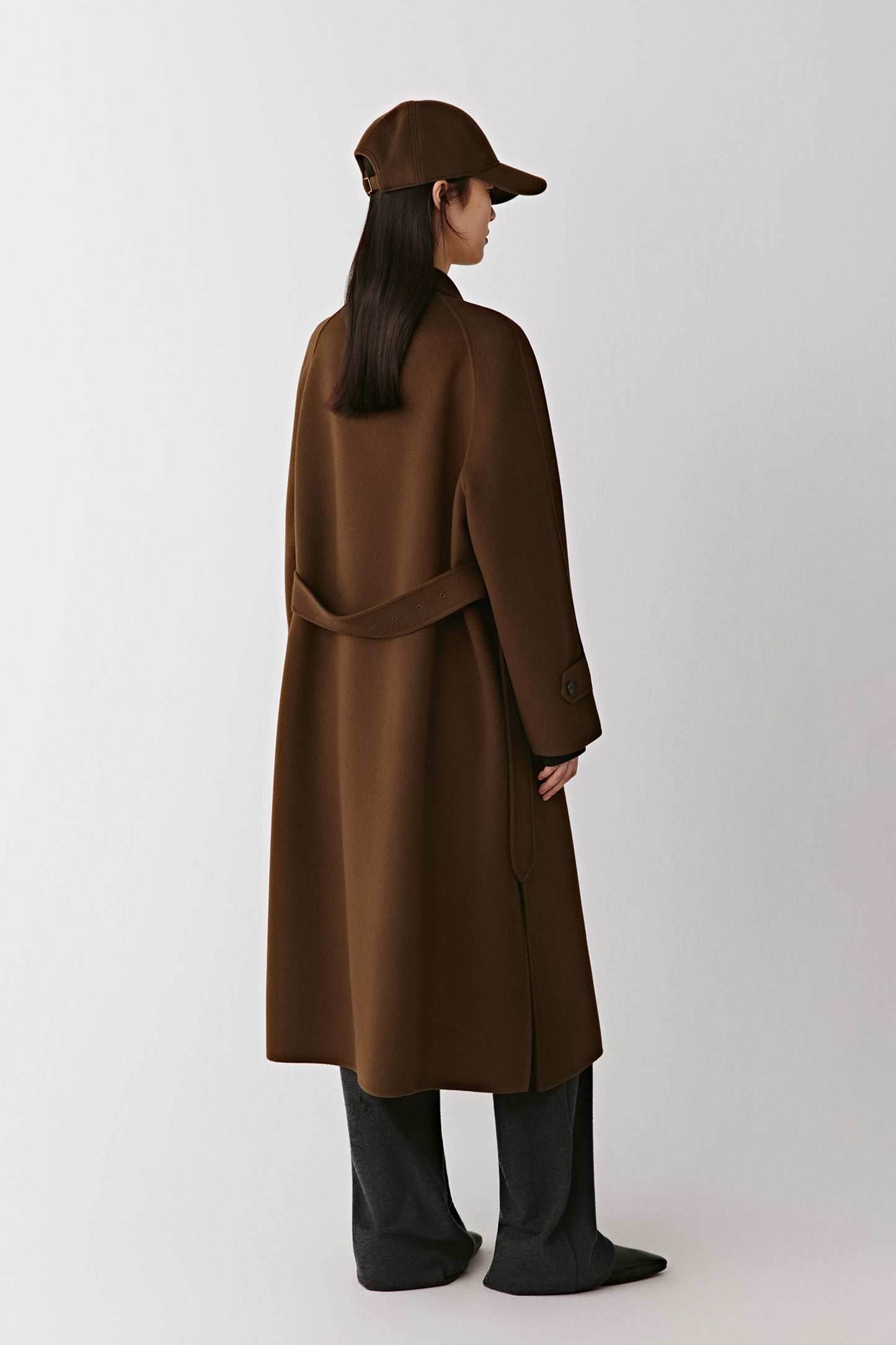Back view revealing the smooth fall of the fabric and the adjustable belt detail.