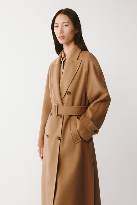 Side view capturing the smooth drape and structure of the coat.