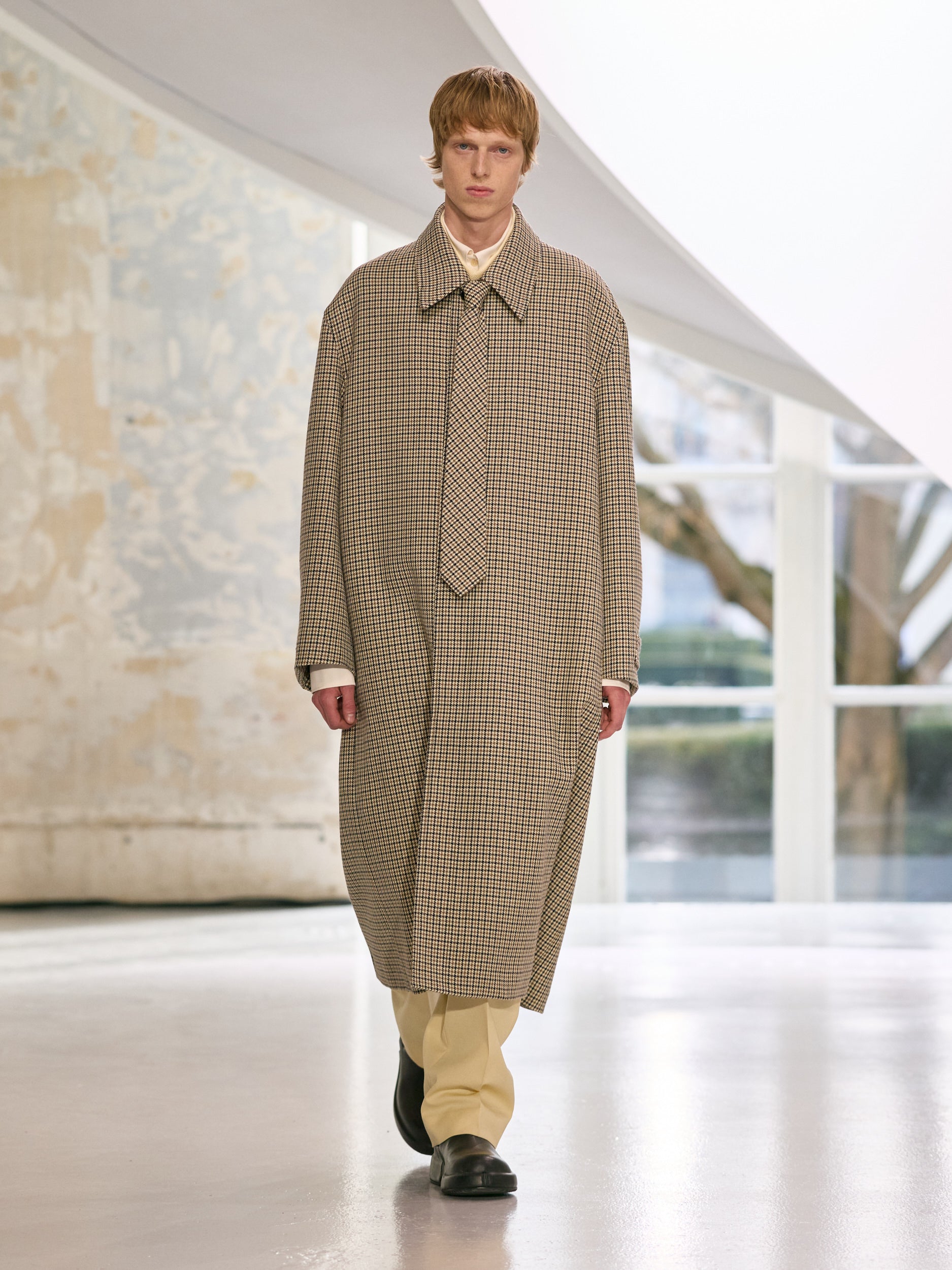 Man wearing a long checkered coat