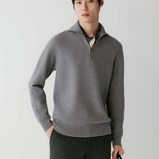 Video Front view of a man wearing a grey cashmere pullover, showing the half-zip funnel neck, long sleeves and straight silhouette.