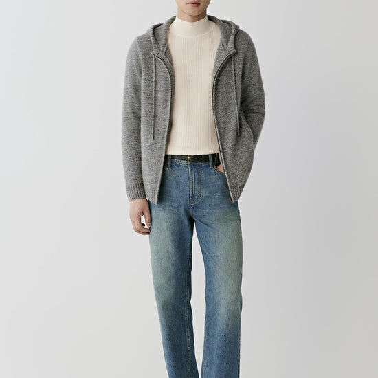 Video Front full-length view of a man wearing the grey melange twisted cashmere cardigan, showing the hood, long sleeves and straight silhouette.