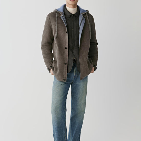 Video Front full-length view of a man wearing the dark brown melange merino wool coat, highlighting the straight silhouette and hooded construction.