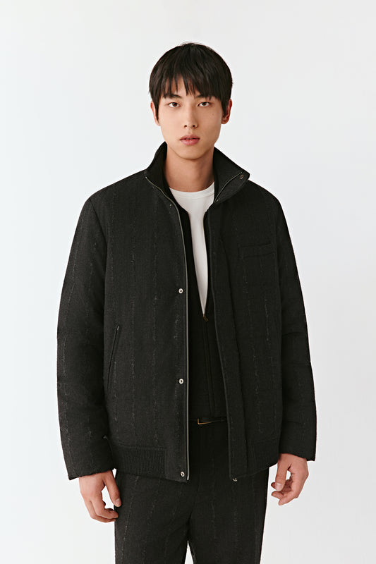 Product video showing a dark striped stretch wool down coat with a stand collar, rotating to display the quilted construction, concealed zip fastening, pockets, and overall silhouette from all angles.