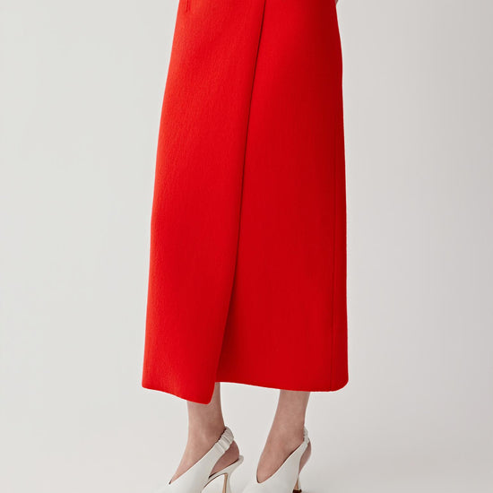 Person wearing a red outfit on a plain background