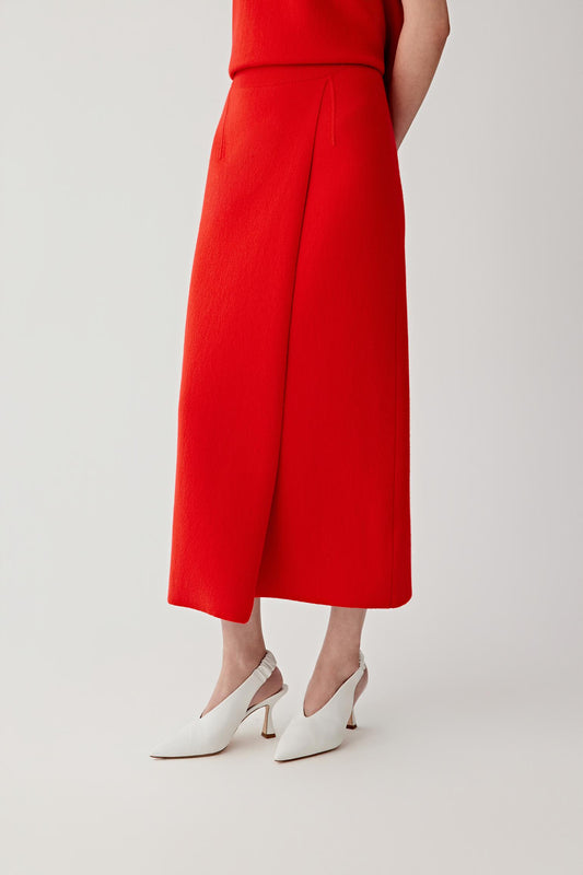 Person wearing a red outfit on a plain background