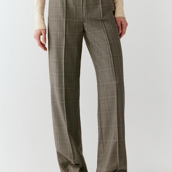 Video of a woman wearing Glen plaid trousers, showing the movement of the straight-leg silhouette and fluid drape as she walks.